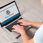 Person On Laptop Building Website using WordPress CMS